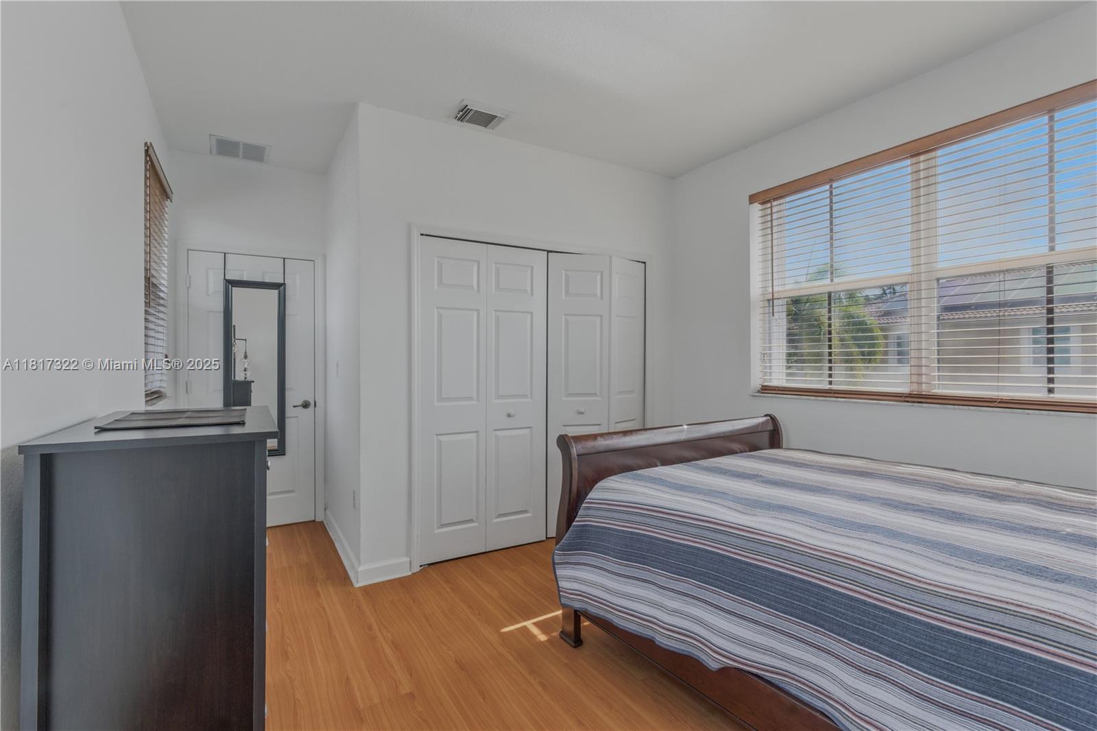 12251 Southwest 122nd Path Miami, FL 33186 - Photo 36 of 56 a bedroom with a bed and cabinets