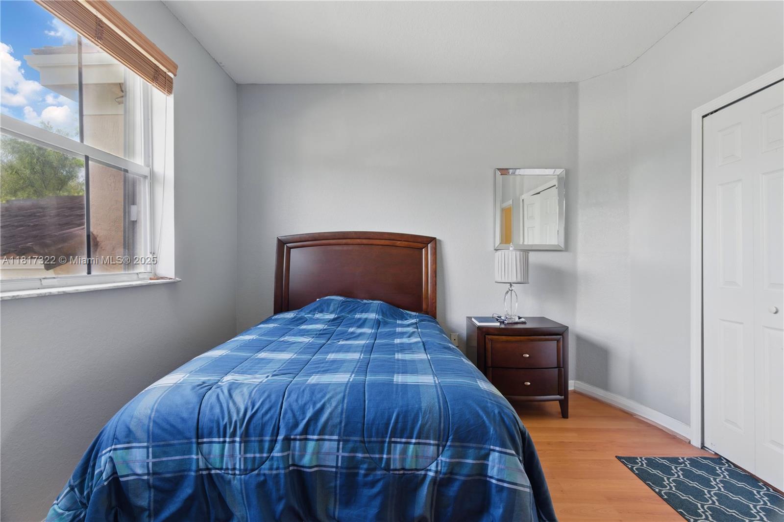 12251 Southwest 122nd Path Miami, FL 33186 - Photo 38 of 56 a bedroom with a bed and window