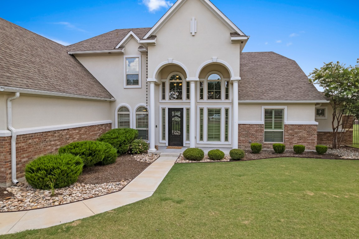 144 Indian Ridge Road Belton, TX 76513 - Photo 1 of 24 View of front of home with stucco siding, brick siding, roof with shingles, and a front lawn