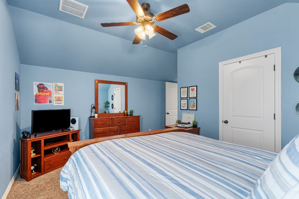 144 Indian Ridge Road Belton, TX 76513 - Photo 11 of 24 Bedroom with carpet floors, a ceiling fan, and lofted ceiling