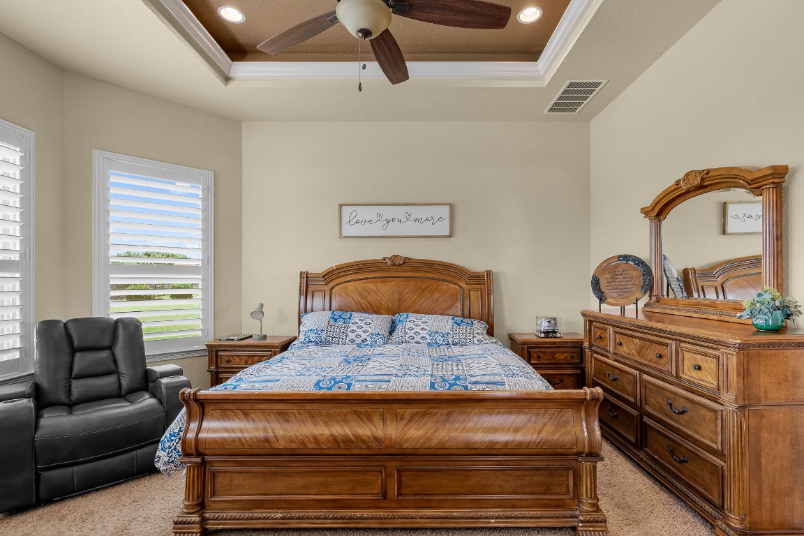 144 Indian Ridge Road Belton, TX 76513 - Photo 14 of 24 Bedroom with a raised ceiling, recessed lighting, crown molding, light carpet, and ceiling fan