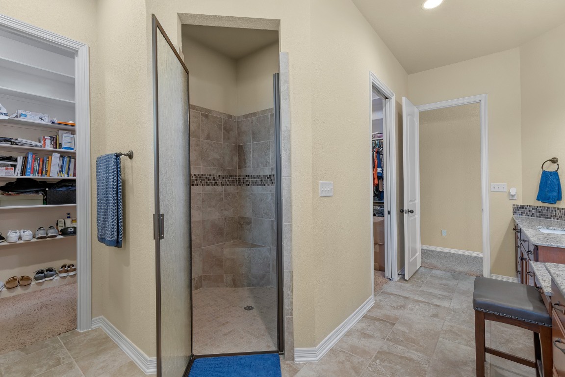 144 Indian Ridge Road Belton, TX 76513 - Photo 18 of 24 Bathroom with a walk in closet, a shower stall, vanity, and recessed lighting