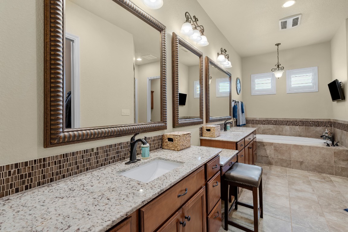 144 Indian Ridge Road Belton, TX 76513 - Photo 19 of 24 Full bath featuring vanity, a bath, light tile patterned floors, recessed lighting, and tasteful backsplash