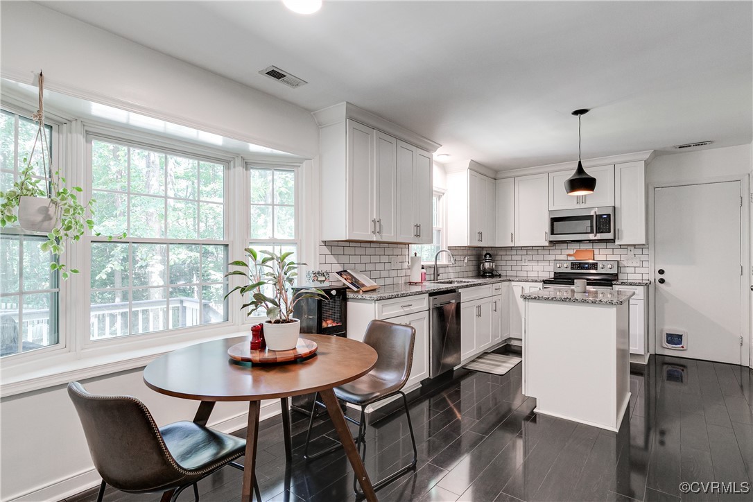 13906 Barnes Spring Road Midlothian, VA 23112 - Photo 11 of 45 a kitchen with a dining table chairs and microwave