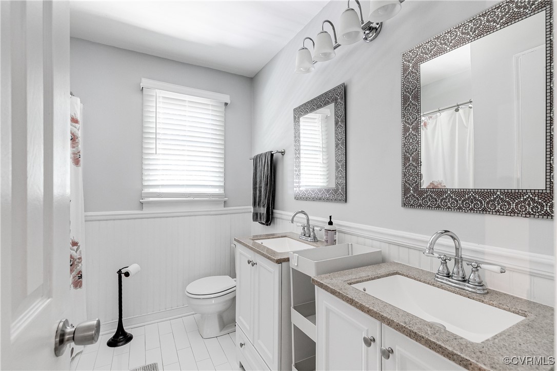 13906 Barnes Spring Road Midlothian, VA 23112 - Photo 28 of 45 a bathroom with a granite countertop sink a toilet and a mirror