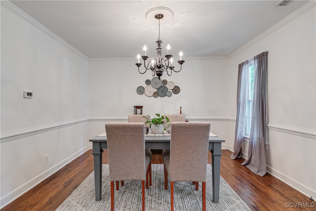 13906 Barnes Spring Road Midlothian, VA 23112 - Photo 8 of 45 a view of a dining room with furniture wooden floor and chandelier