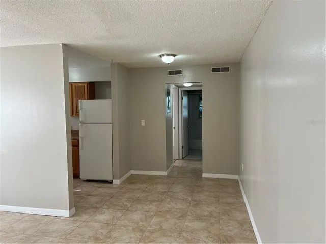 an empty room with closet and a bathroom