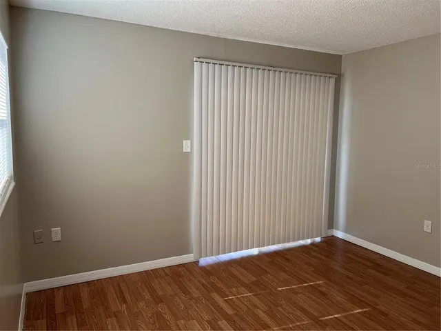 a view of room with wooden floor