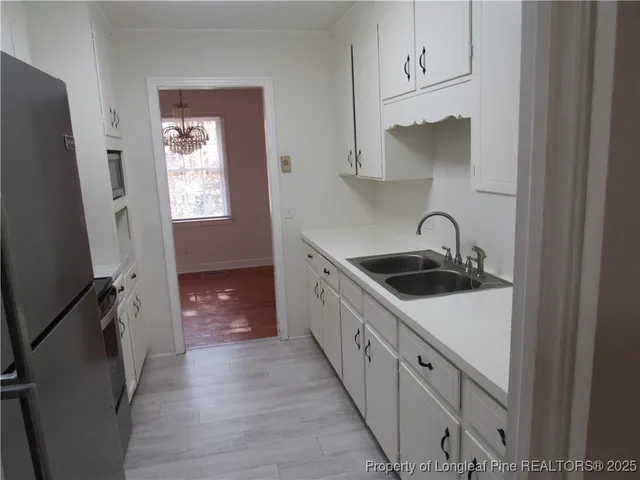 a kitchen with stainless steel appliances a sink stove and cabinets
