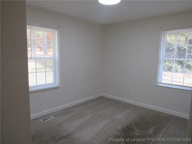 a view of a small space with wooden floor and a window