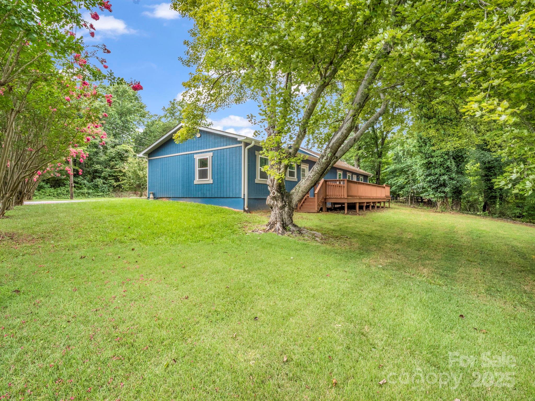 611 Peniel Road Columbus, NC 28722 - Photo 3 of 28 a white house with a big yard and large trees
