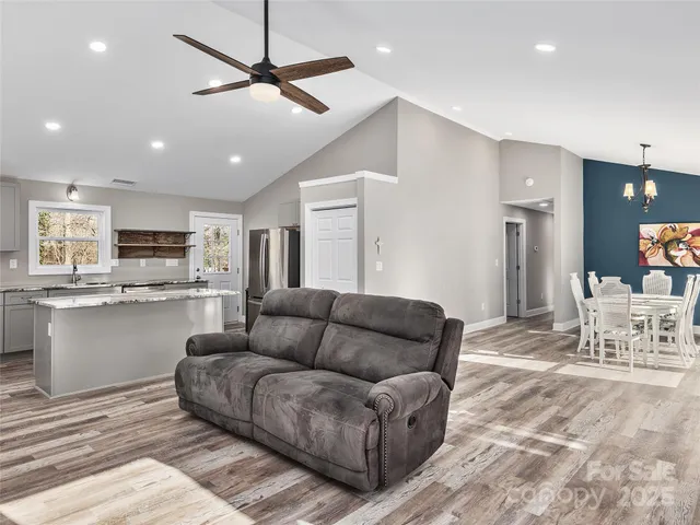 a living room with furniture and kitchen view
