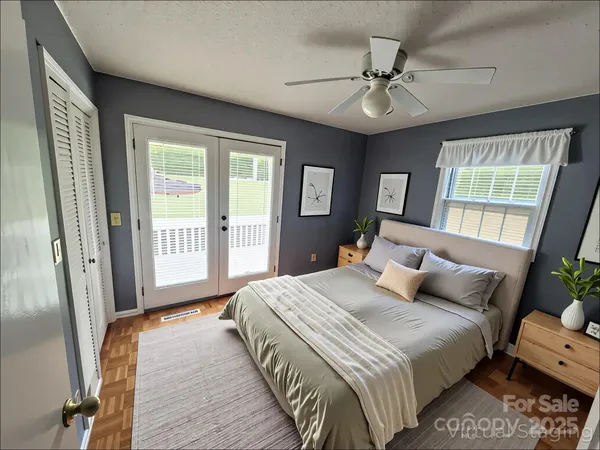 a bedroom with a bed and a chandelier
