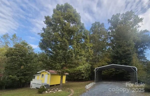 a view of a parking space with utility and car parked