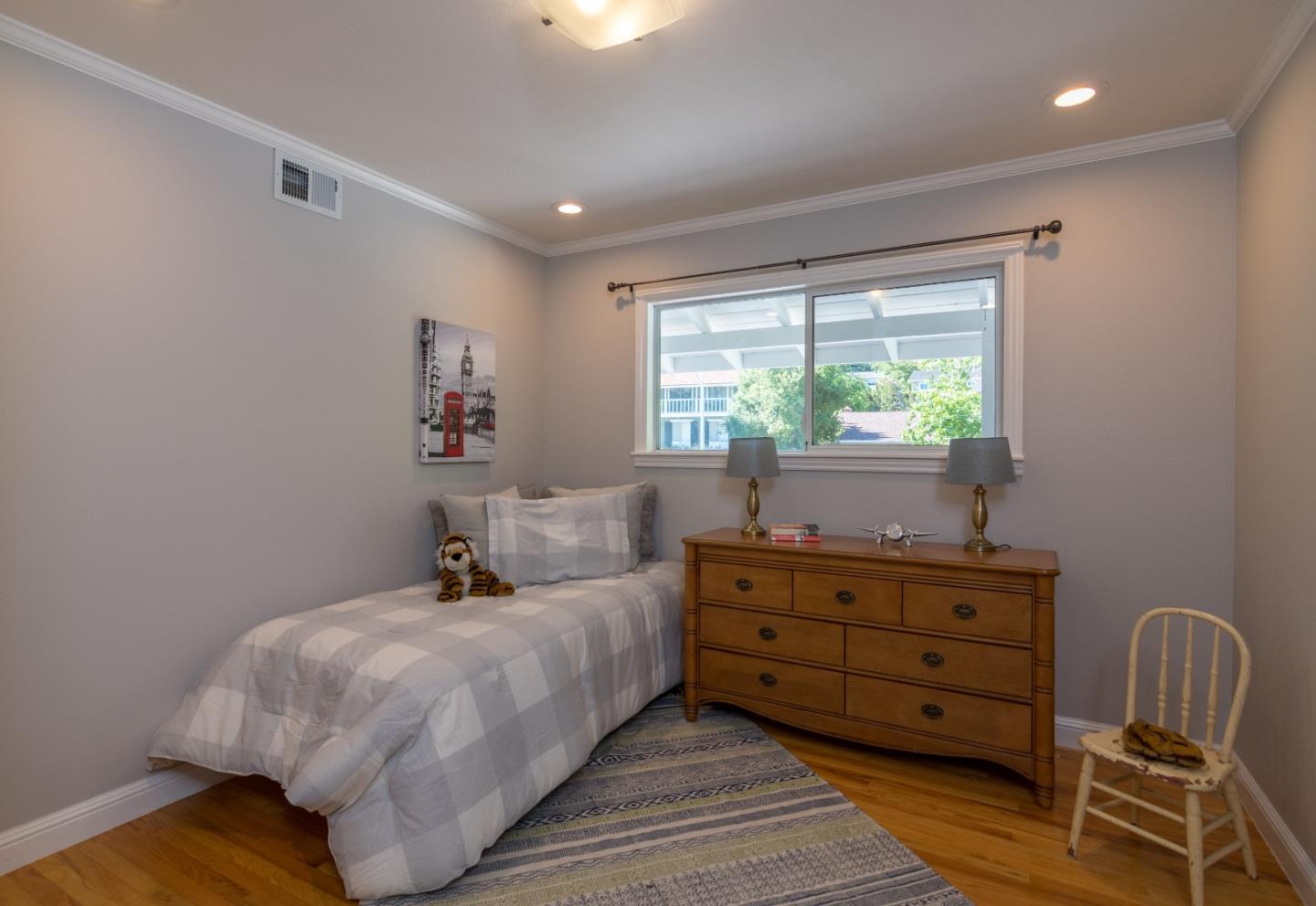 115 Belcrest Drive Los Gatos, CA 95032 - Photo 17 of 30 a bed room with a bed and a chair