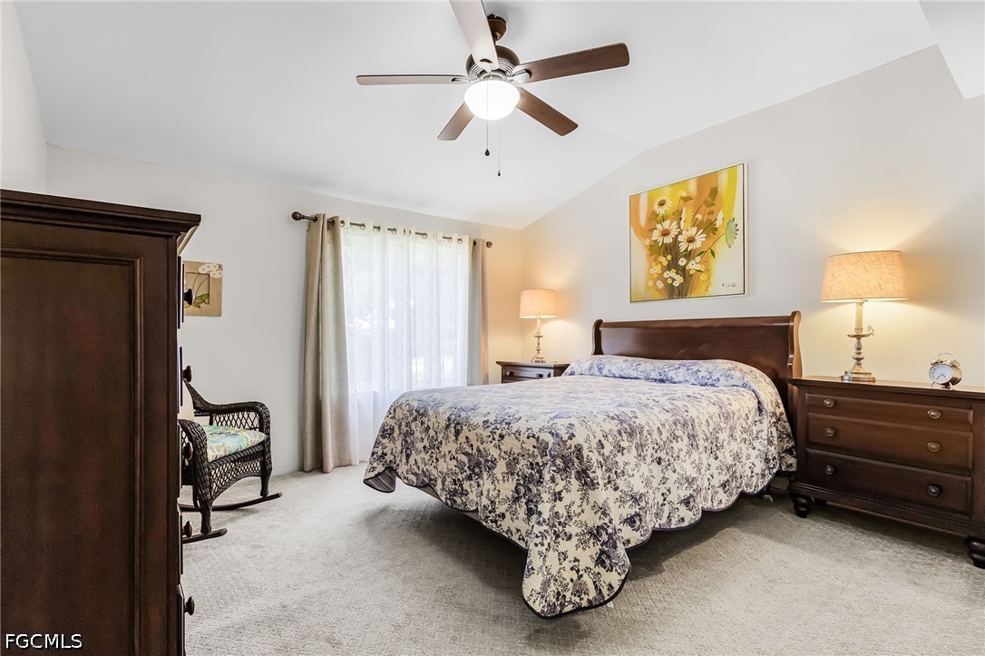 5 Erica Street Alva, FL 33920 - Photo 9 of 37 a bedroom with a bed and a chandelier