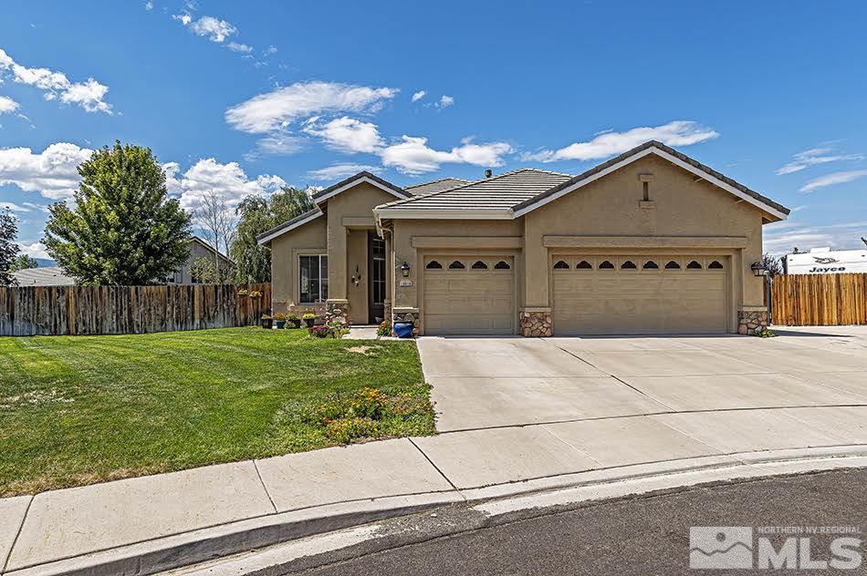 10010 Stonechase Court Reno, NV 89521 - Photo 1 of 33 a front view of a house with a yard and garage