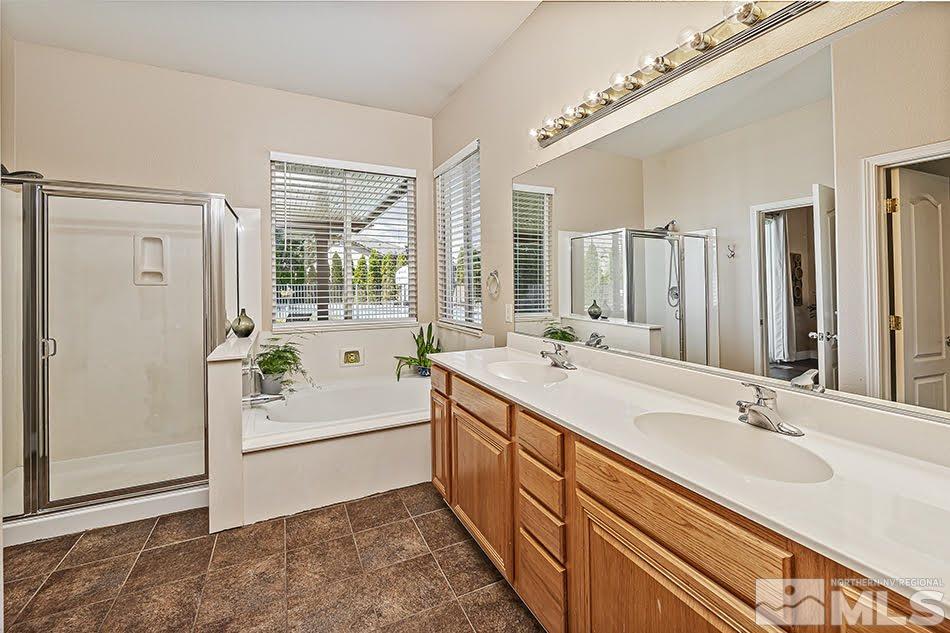 10010 Stonechase Court Reno, NV 89521 - Photo 12 of 33 a spacious bathroom with a double vanity sink a mirror and a bathtub