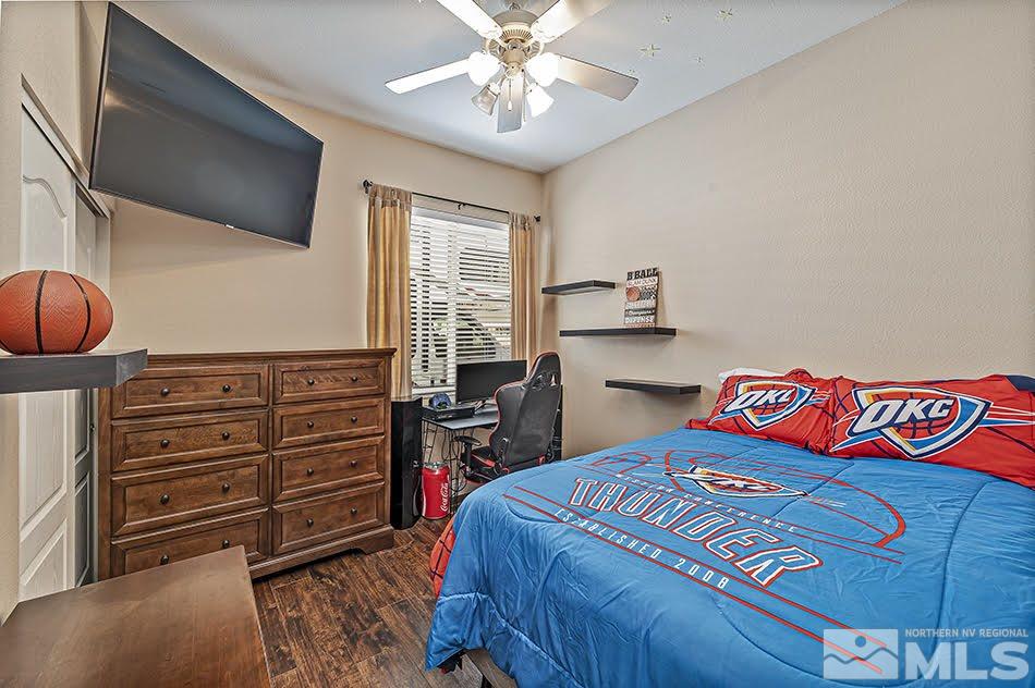 10010 Stonechase Court Reno, NV 89521 - Photo 13 of 33 a bedroom with a bed and a chandelier