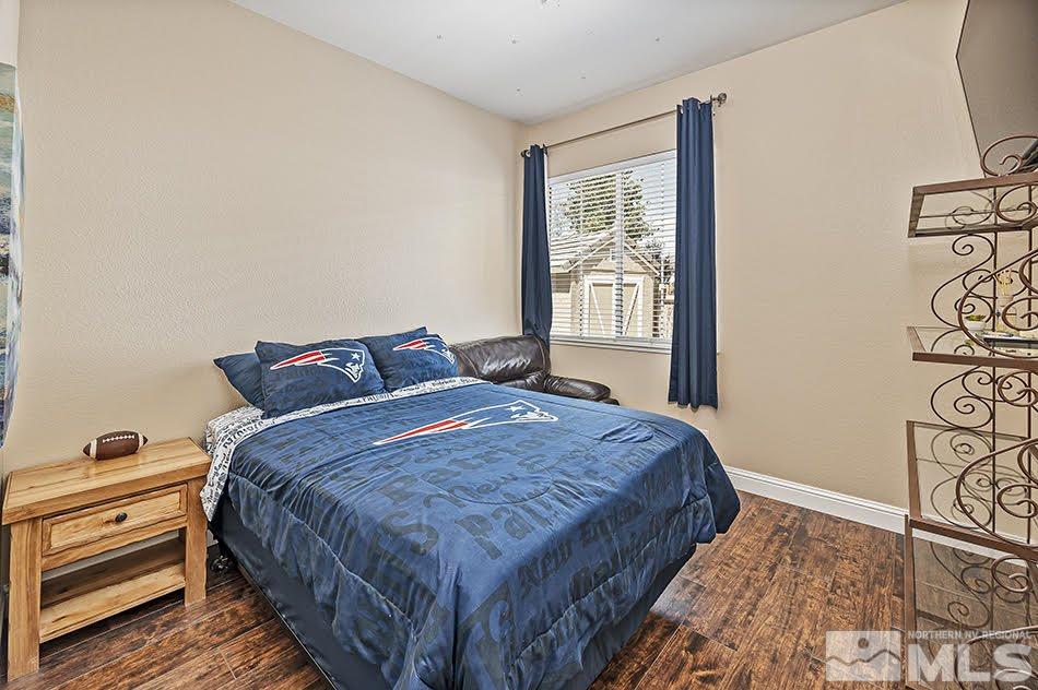 10010 Stonechase Court Reno, NV 89521 - Photo 14 of 33 a bedroom with a bed and a window