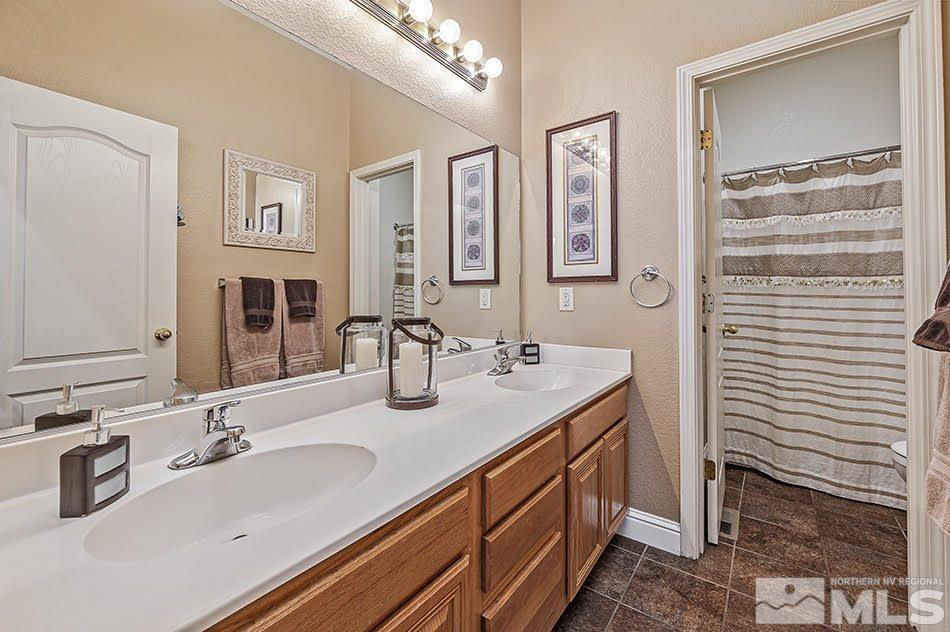 10010 Stonechase Court Reno, NV 89521 - Photo 15 of 33 a bathroom with a sink double vanity and a mirror