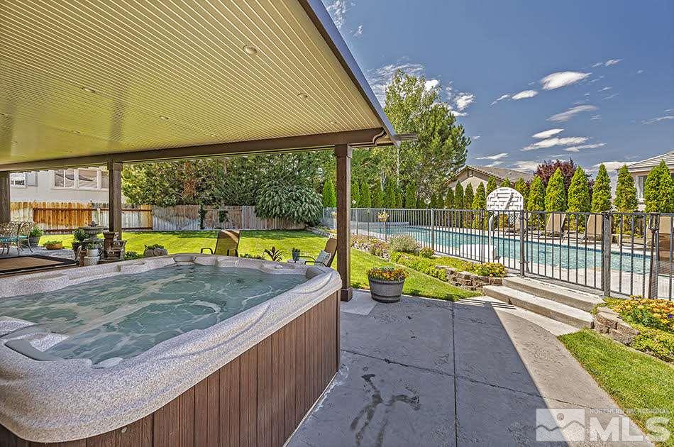 10010 Stonechase Court Reno, NV 89521 - Photo 17 of 33 a view of a swimming pool with a lounge chairs