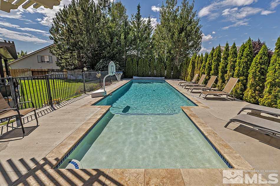 10010 Stonechase Court Reno, NV 89521 - Photo 20 of 33 a view of a swimming pool with a patio and fire pit