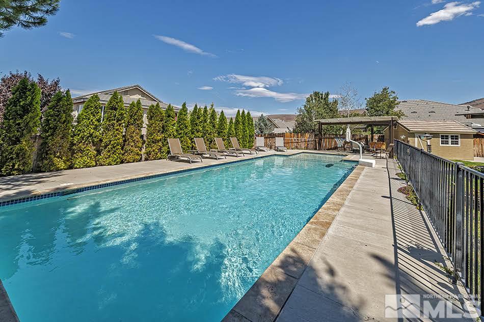 10010 Stonechase Court Reno, NV 89521 - Photo 21 of 33 a view of a swimming pool with a garden