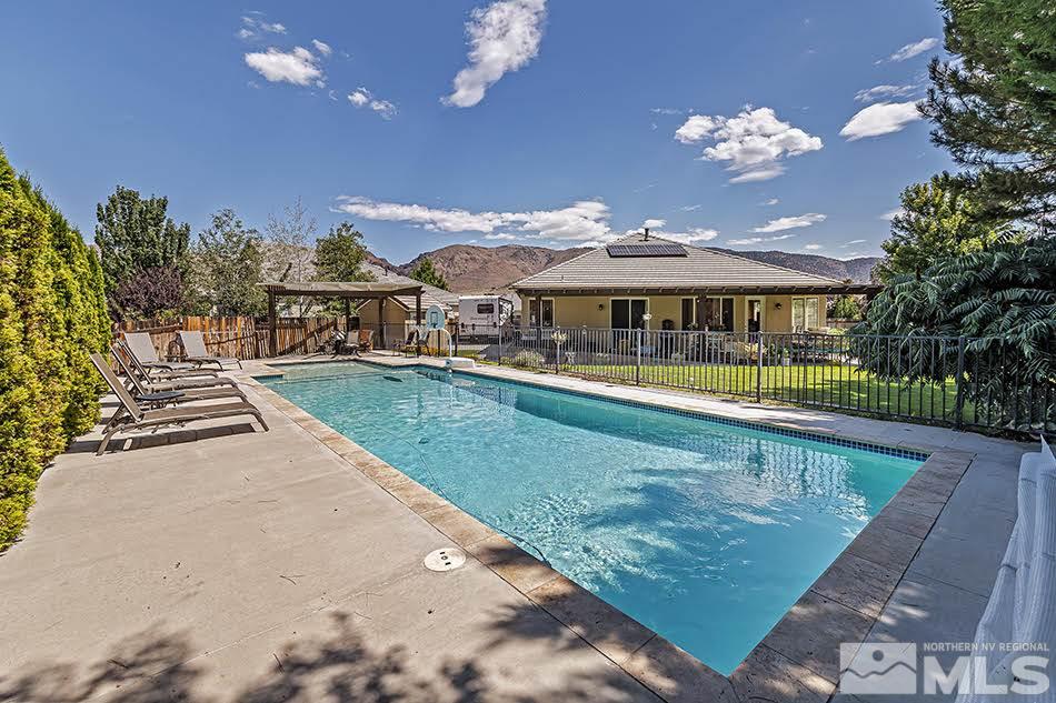 10010 Stonechase Court Reno, NV 89521 - Photo 22 of 33 swimming pool view with a seating space and a garden
