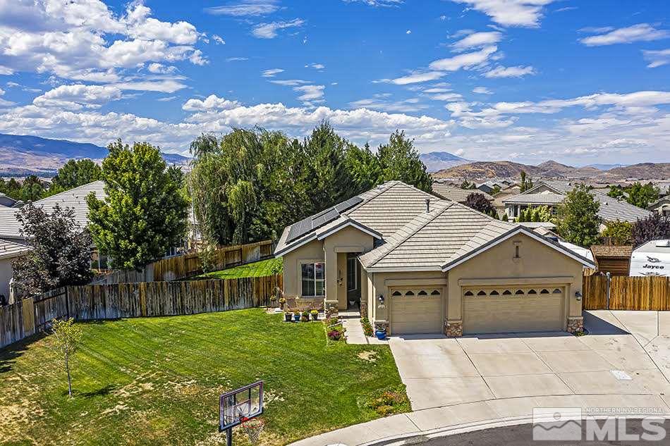 10010 Stonechase Court Reno, NV 89521 - Photo 26 of 33 a view of a big house with a big yard and potted plants in front of it