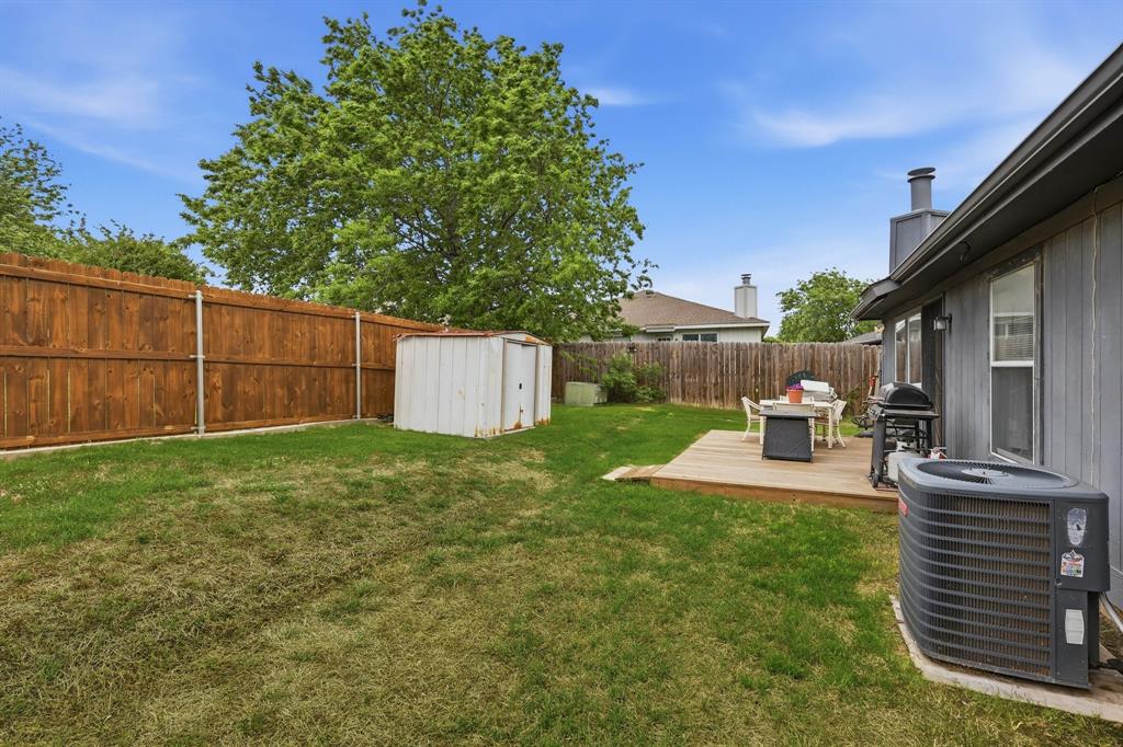 4217 Broken Arrow Road Fort Worth, TX 76137 - Photo 39 of 40 a view of a backyard with table and chairs and wooden fence