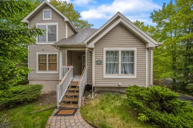 a front view of house with yard and green space