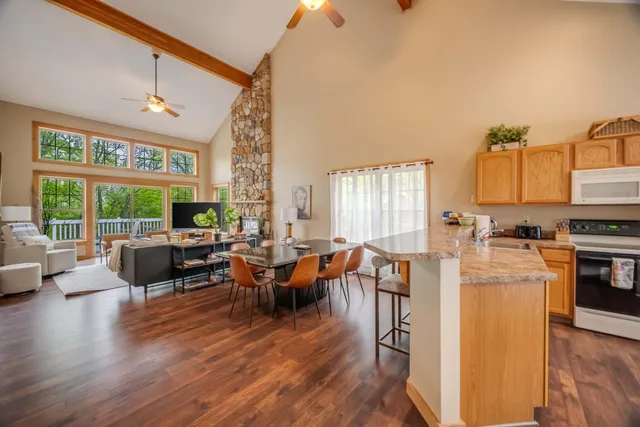 a living room with fireplace furniture and a large window