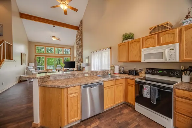 a kitchen with stainless steel appliances granite countertop a stove and a sink