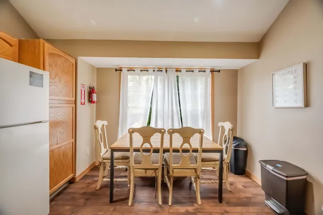 a dining room with furniture and window