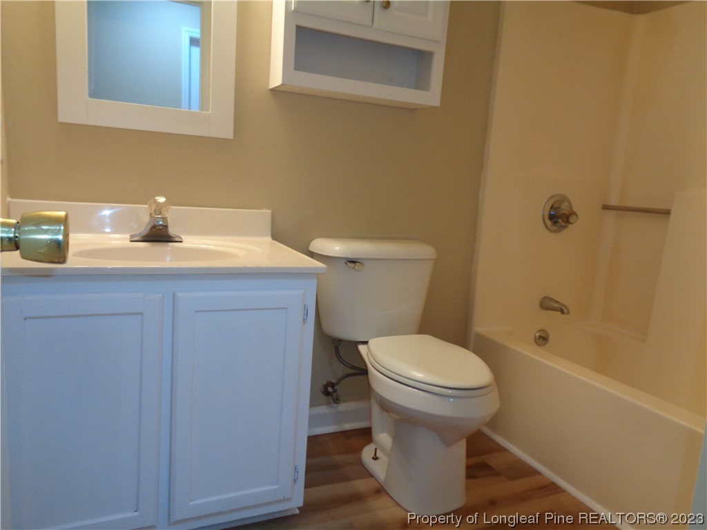 108 Dallas Street Lumberton, NC 28358 - Photo 11 of 15 a bathroom with a granite countertop toilet sink and mirror