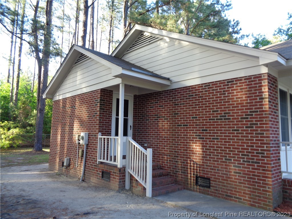 108 Dallas Street Lumberton, NC 28358 - Photo 3 of 15 a view of a house with a yard and wooden fence
