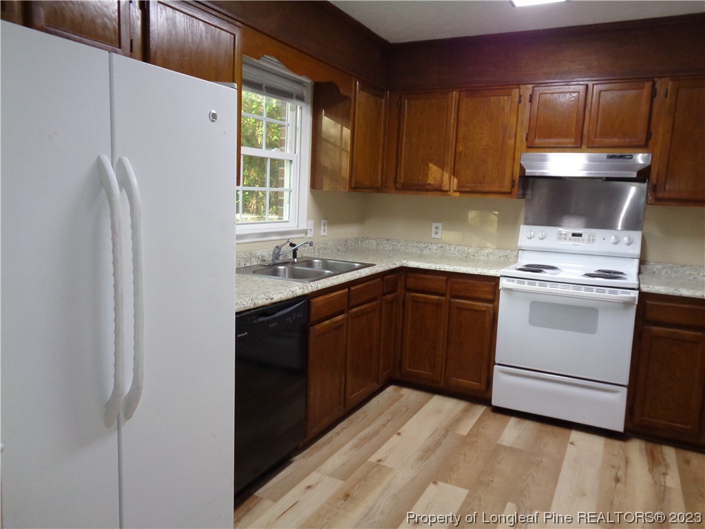 108 Dallas Street Lumberton, NC 28358 - Photo 8 of 15 a kitchen with a sink a stove and refrigerator