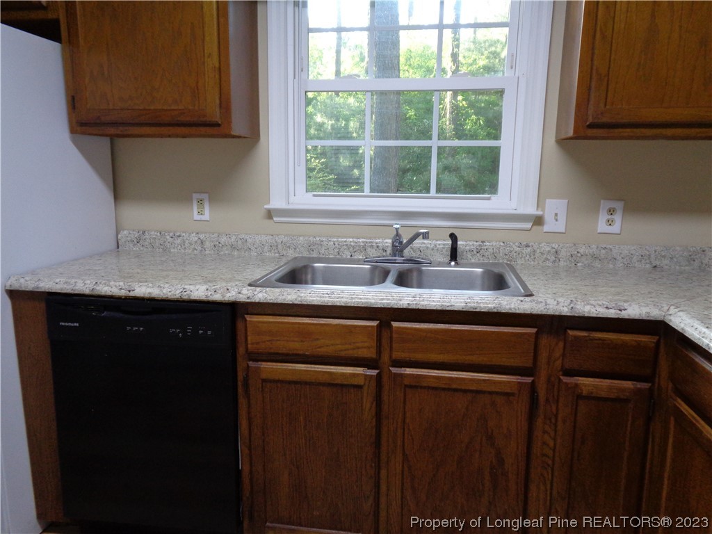 108 Dallas Street Lumberton, NC 28358 - Photo 10 of 15 a kitchen with granite countertop cabinets sink and window