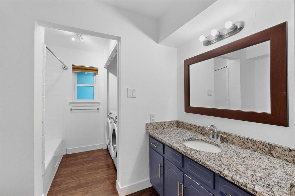 4857 Fallon Place Dallas, TX 75227 - Photo 13 of 19 Bathroom featuring vanity, dark wood finished floors, bathing tub / shower combination, and separate washer and dryer