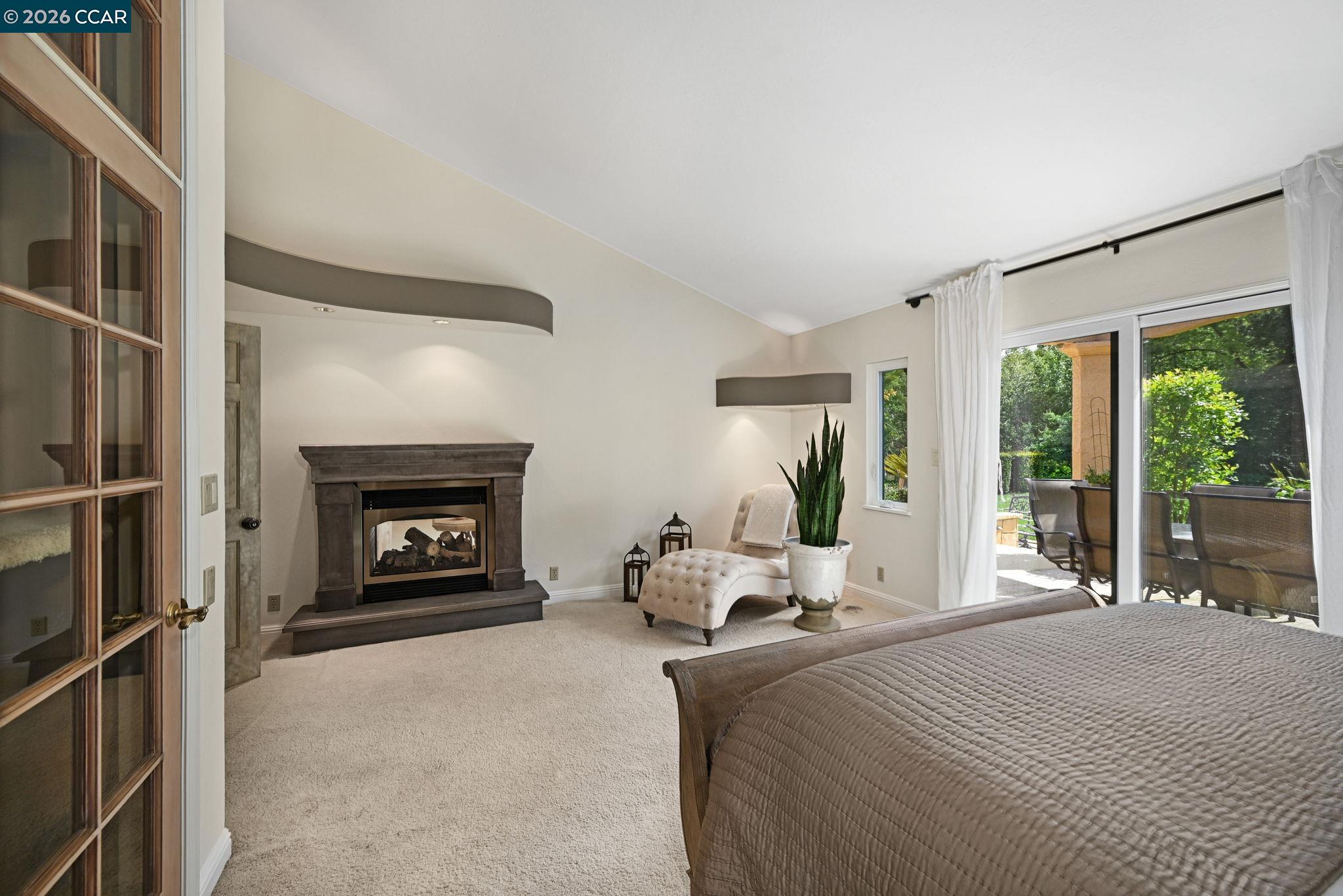 490 St Marys Road Lafayette, CA 94549 - Photo 25 of 61 a bedroom with a bed and a fireplace
