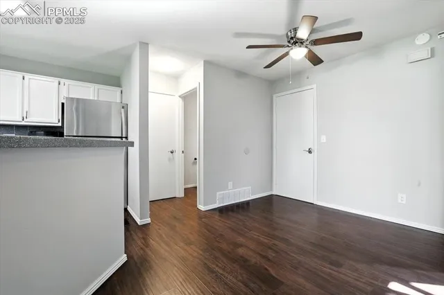a view of empty room with wooden floor