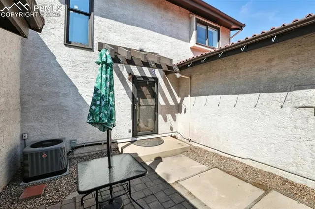 a backyard of a house with table and chairs