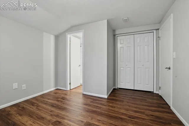 a view of a room with wooden floor