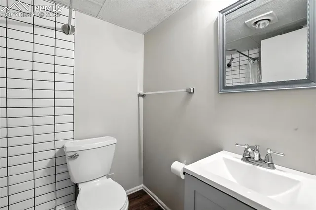 a bathroom with a toilet sink and mirror