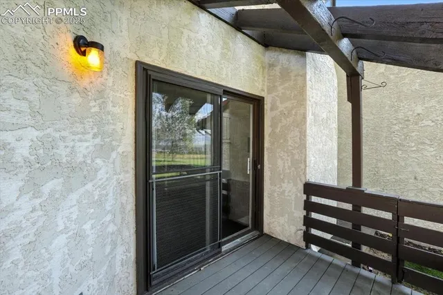 a view of a door and wooden floor