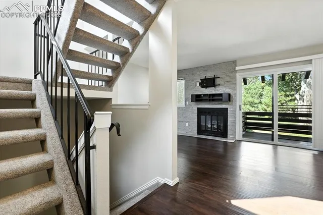 a view of entryway and hall with wooden floor