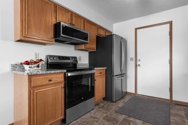 a view of backyard with deck and garden