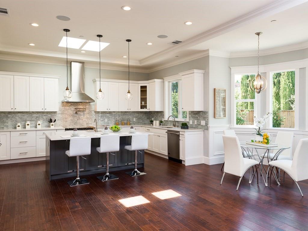 221 Cherry Lane Campbell, CA 95008 - Photo 6 of 23 a kitchen with a table chairs wooden floors and white cabinets