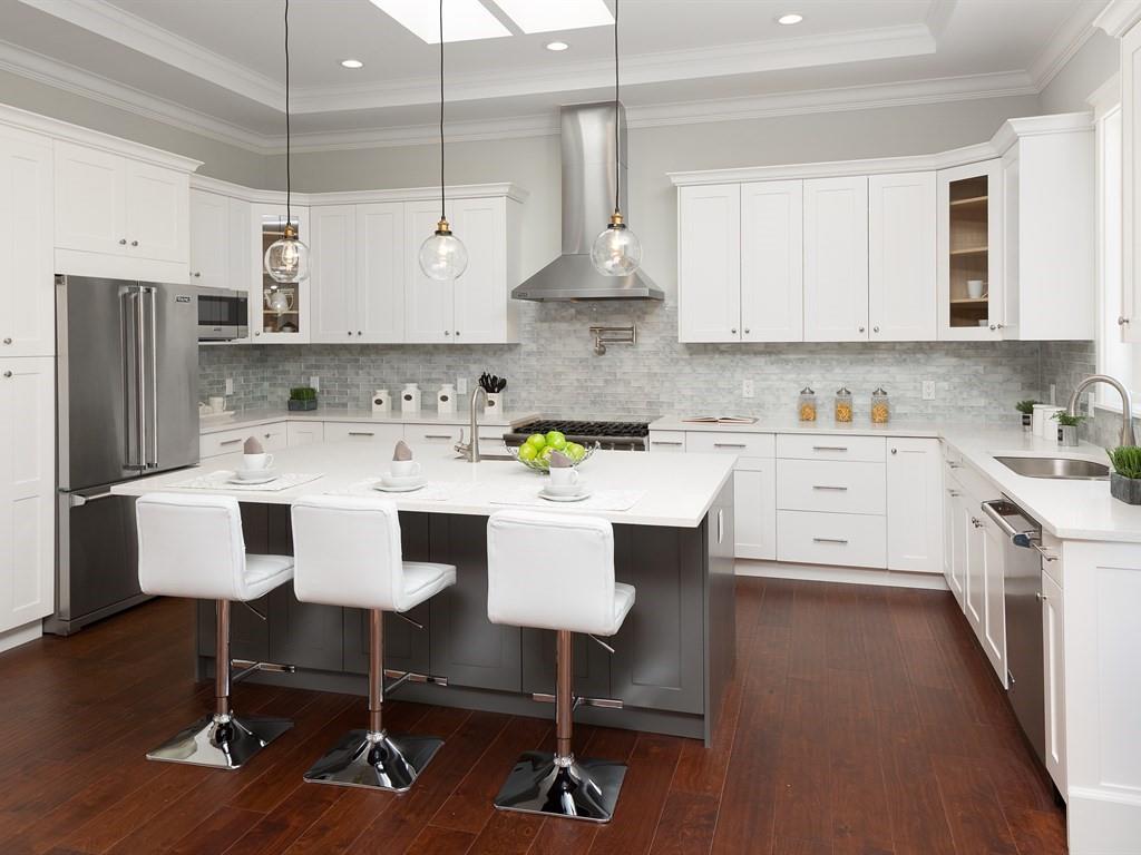 221 Cherry Lane Campbell, CA 95008 - Photo 8 of 23 a kitchen with stainless steel appliances kitchen island granite countertop a sink a stove a refrigerator and white cabinets with wooden floor